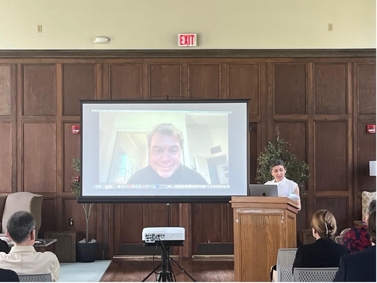 person at a podium and person on a big screen